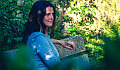 woman sitting peacefully on a bench out in nature